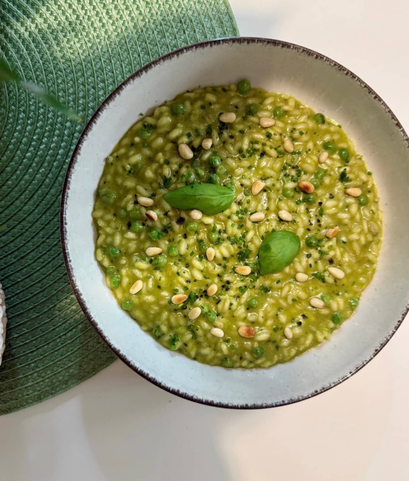 Basil, pine nuts, a bowl of green.