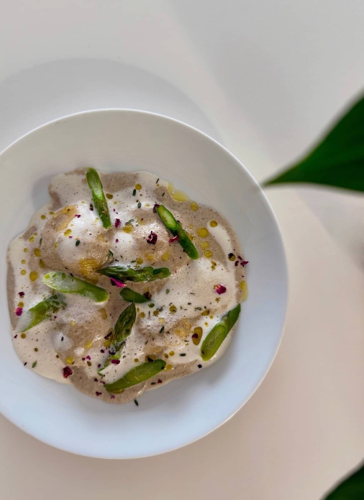 Silk ravioli under a light foam, finished with tips of asparagus.