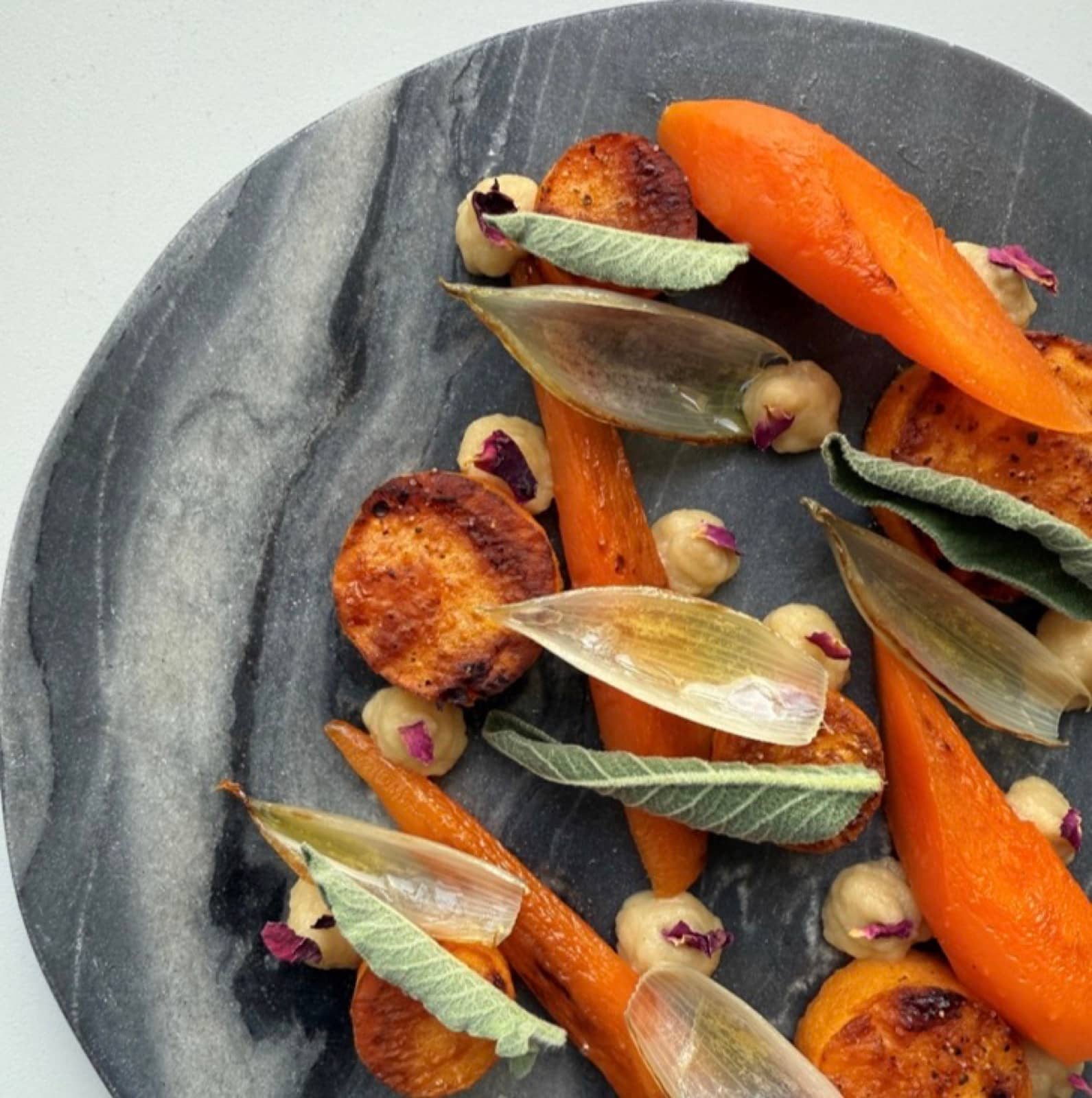 Carrot, shallot and roasted rounds on marble.