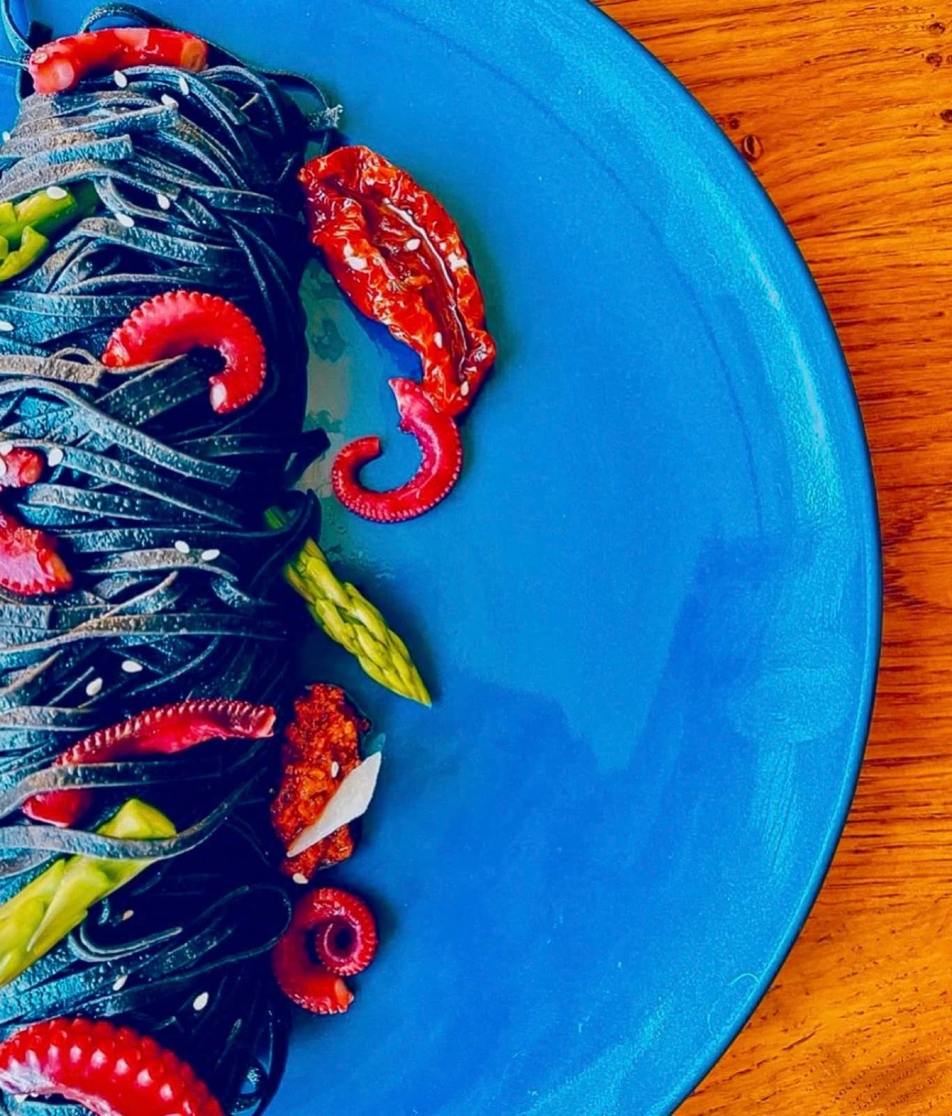 Octopus, asparagus, a blue plate.