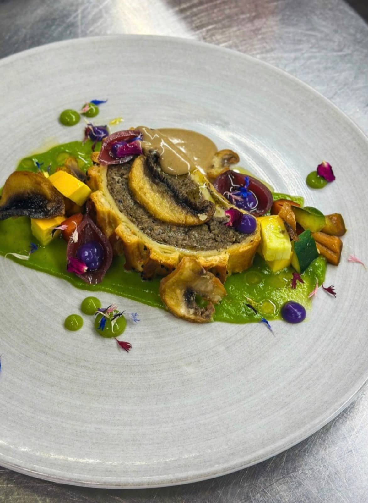 Puff pastry, mushroom duxelles, pea puree and summer vegetables.