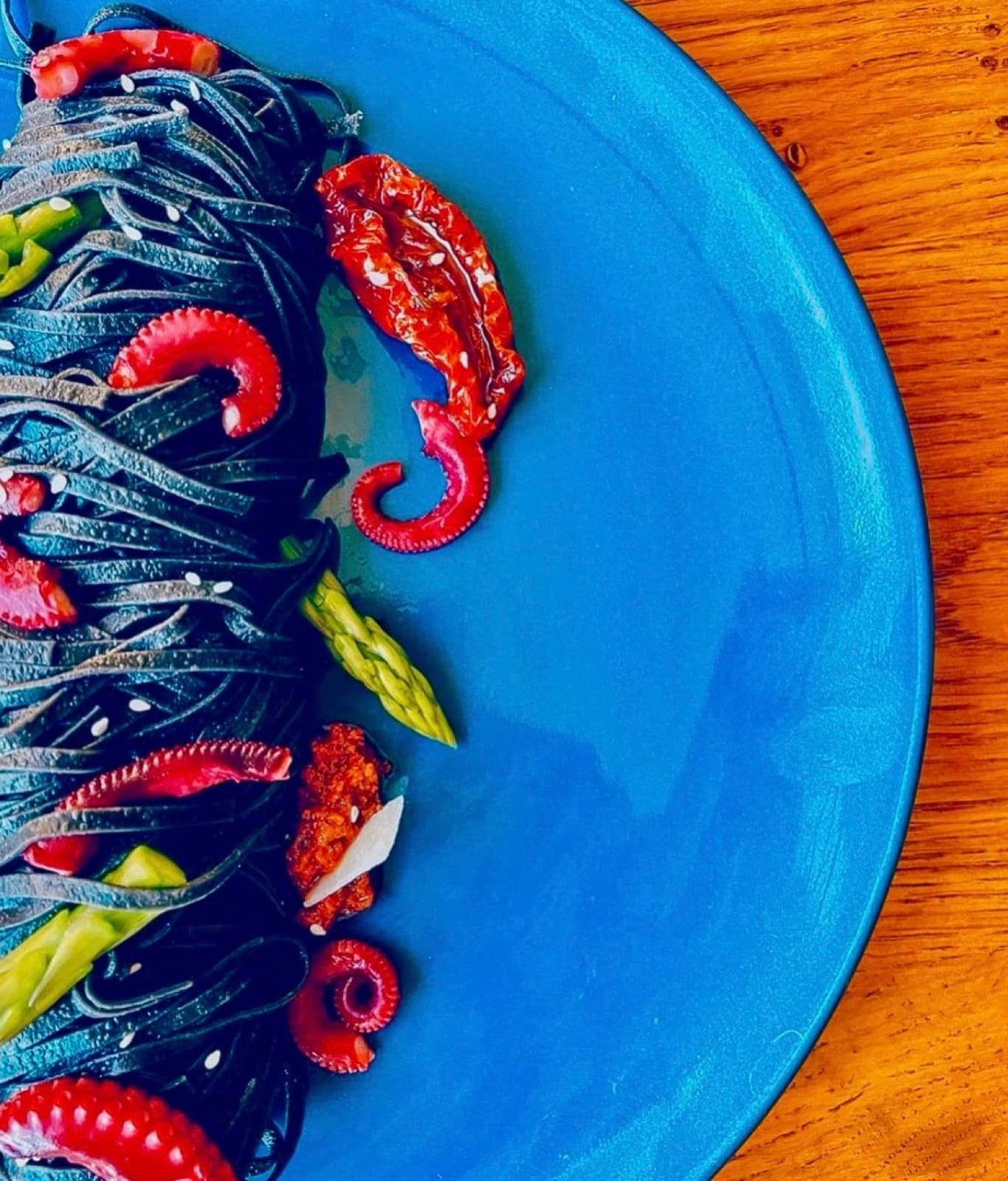 Octopus, asparagus, a blue plate.